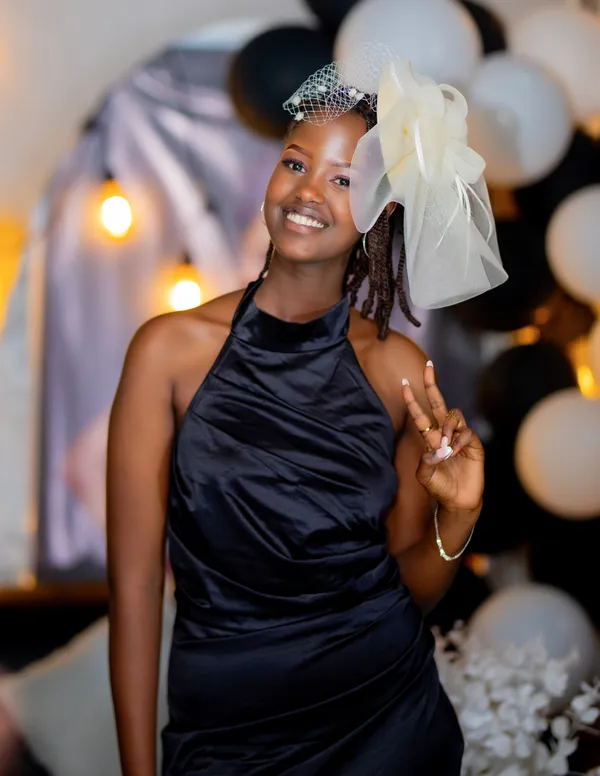 Woman in a black dress posing at a celebration