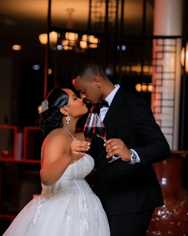 Bride and groom sharing a kiss at their wedding reception
